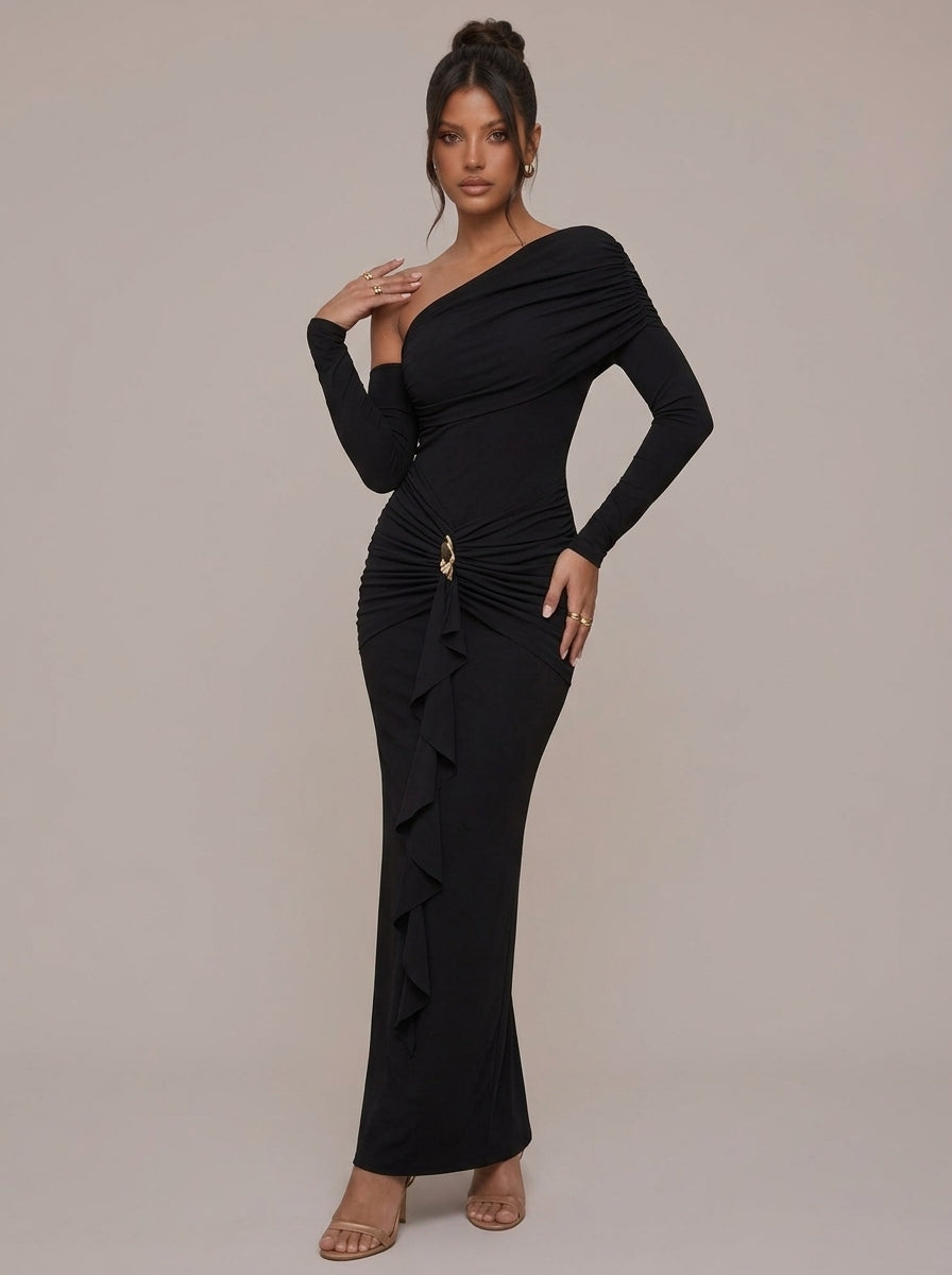 Rae Sera black asymmetric maxi dress with long sleeves, ruched waist, and gold-tone hip detail