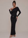 Rae Sera black asymmetric maxi dress with long sleeves, ruched waist, and gold-tone hip detail