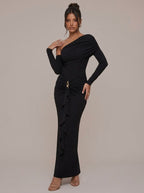 Rae Sera black asymmetric maxi dress with long sleeves, ruched waist, and gold-tone hip detail